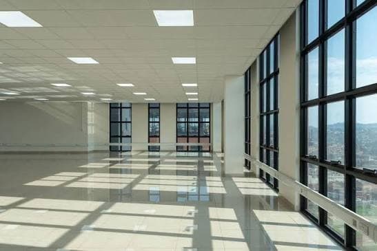 A modern open-plan office space with floor-to-ceiling windows